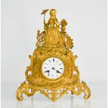 A 19th century gilt metal mantle clock, cast with a model of lady with parasol surmount, Roman