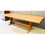 Don Craven 'The Foxman' oak dining table, the three plank adzed top above a trestle base, bearing