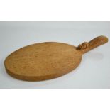 A Robert Thompson The Mouseman cheese board, carved to the handle with the trademark mouse, 37 by