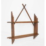 An Arts & Crafts style wall shelf, composed of graduated slats, 91 by 89cm.