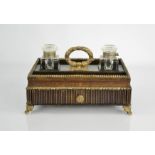 A 19th century ink stand, with two glass inkwells, brass beaded borders, a single drawer and