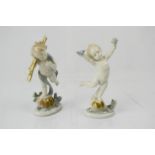 A pair of German porcelain cherub figurines, 14cm high.