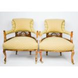 An Edwardian pair of tub chairs, with green upholstery and mahogany frame, raised on castors.