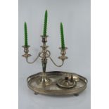 A silver plated tray, three branch silver plated candelabra and a silver plated chamberstick.