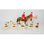 A Beswick Hunt set, comprising two horses and riders, fox and twelve hounds. Riders 21cms tall