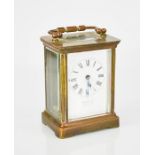 A Harrods of London brass carriage clock, 11cm high.