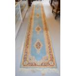 A large 19th century blue runner, with dark blue and cream borders, and stylised motifs to the