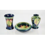 Three examples of Moorcroft in the grape and leaf pattern: trinket dish 11cm diameter, vase 9cm high