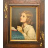 Manner of Millais, portrait of a young girl praying, oil on canvas laid onto board, in an Arts &