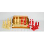 A 19th century carved chess set in hinged mahogany case, one set stained red.