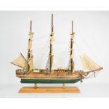 An antique handmade wooden model Young America clipper ship 1853, raised on a stand bearing a