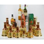 A group of Wade Bells Whiskey bottles, various wines and a bottle of Ouzo.