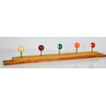 A coat rack composed of pool ball hooks, 72cm long.