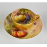 A Royal Worcester cup and saucer painted with fruits, signed Ricketts, with gilded interior. 3.5cms