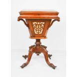 A Victorian walnut sewing table with drawer and sliding box base composed of decorative pierced