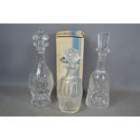 Three Waterford crystal decanters, one boxed.