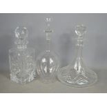 An Edwardian decanter etched with stars 31cm high, and two cut glass decanters.