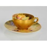 A Royal Worcester cup and saucer painted with fruits, signed Barker and Everett, with gilded