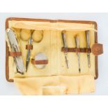 A silver manicure set, Birmingham 1928, in tan leather case.