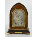 An Edwardian mahogany, ebonised and brass mantle clock, with a silvered Roman numeral dial, with