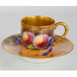 A Royal Worcester cup and saucer painted with fruit signed Harper, with gilded interior. 5cms tall