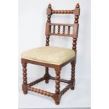 A 19th century oak bobbin turned hall chair, with upholstered seat.