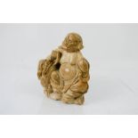 A carved soapstone Buddha, 12cm high.