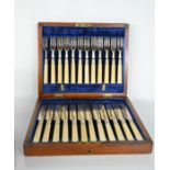 A 19th century boxed set of fish knives and forks, with silver ferules, blue velvet lined interior.