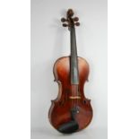 A violin labelled Joseph Guarnerius fecit Cremonae anno 1726 IHS, the two-piece back of medium curl,