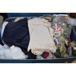 A suitcase of vintage fabric and men's jackets.