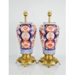 A pair of Imari table lamps, with gilt metal bases, 14ins high.