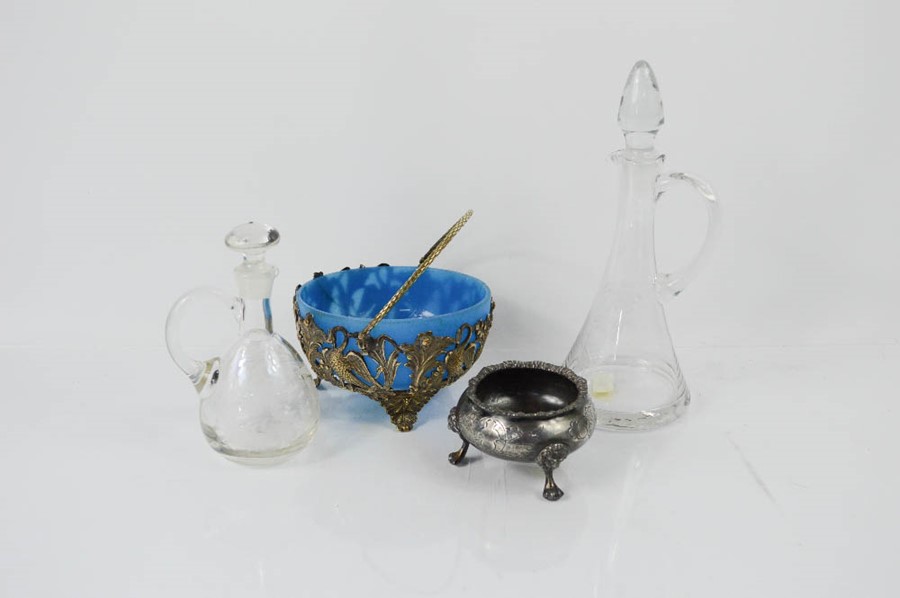 Two antique glass bottles, a blue glass bowl and salt.