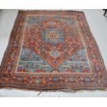 A 19th century rug, with blue and red central ground, highly decorated borders and central motifs,