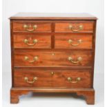 A Georgian mahogany chest of drawers, of small proportions, comprising four short and two long