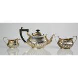 A silver three piece tea set comprising tea pot, sugar bowl and milk jug, Birmingham 1903, 22.5toz.