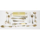 A group of silver to include sugar tongs, spoons, silver handled button hook and shoe horns, and