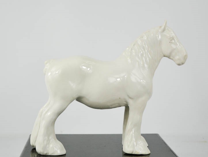 A Beswick white glazed shire horse, 22cm high.