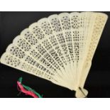 A Victorian bone carved fan, each panel pierced with decoration.