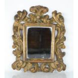 A late 18th / early 19th century Italian giltwood wall mirror, the frame carved with bold