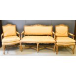 A French 19th century style settee and two matching armchairs, upholstered in cream cotton.