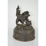 A Chinese bronze urn cover with figure of Shi Shi - 26cm