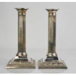 A pair of silver candlesticks, with reeded columns, Sheffield 1909, 20cm high, with weighted