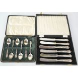 A set of silver spoons, 1.21toz, together with a set of silver handled butter knives, both in