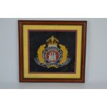 A framed Suffolk regiment bullion badge