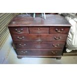 A Georgian mahogany chest of three short over three long graduated drawers, raised on bracket