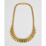 A 9ct gold flat link Egyptian style necklace, in presentation case, 42cm long, 21g.