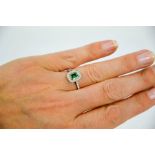 An 18ct white gold, emerald and diamond ring, size N½, 3.7g.