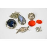 A silver Bedfordshire & Hertfordshire brooch with two snakes set with pink and green eyes, a