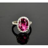 A platinum, pink tourmaline and diamond ring, the pink tourmaline 4.84cts, the bordering diamonds,