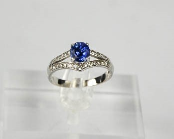 A 14ct white gold, sapphire and diamond ring, the sapphire approximately 1ct, the diamonds totalling